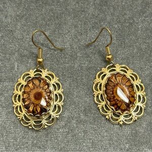 Gold tone flower cat eye oval dangling earrings